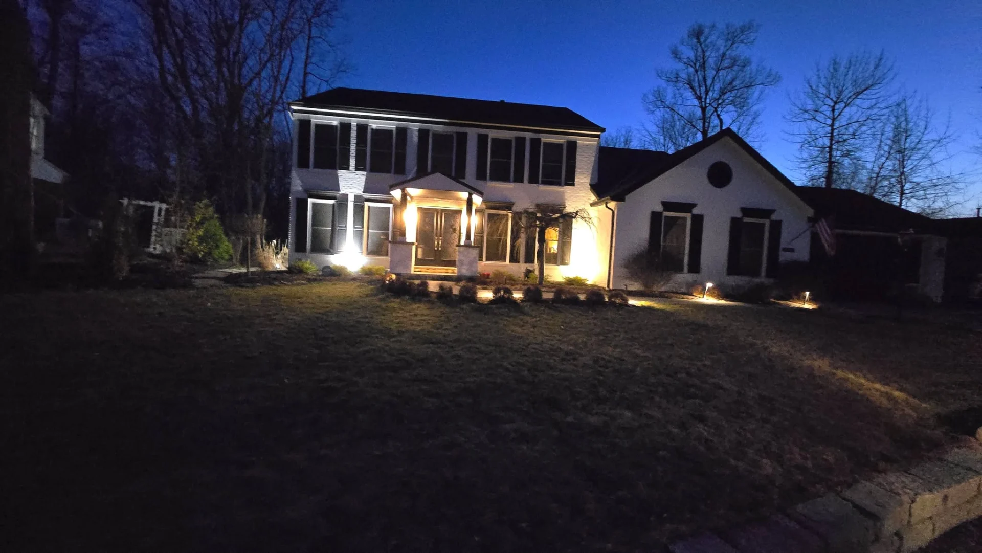Front yard and exterior home lighting at dusk, showcasing architectural uplighting by Serene Aqua in Cincinnati, OH